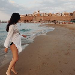 Woman on beach against sky