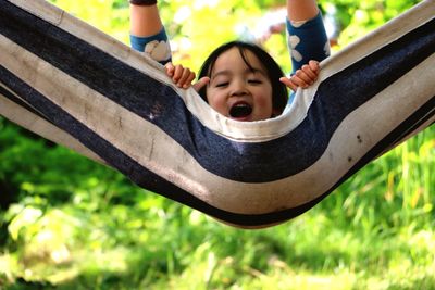 Low angle view of boy playing on slide at park