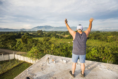 Man praising and worshipping god early in the morning from rooftop.