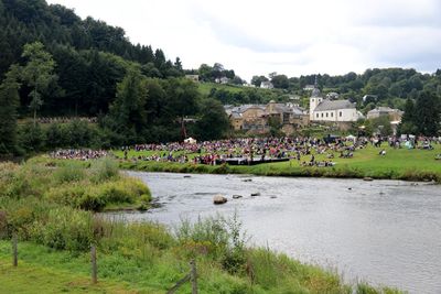 Scenic view of river by town against sky