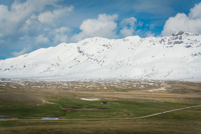 Scenic view of snowcapped mountains against sky