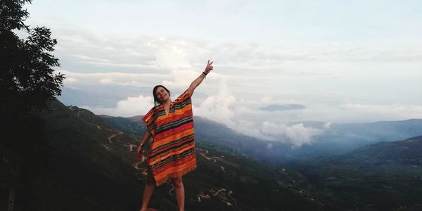 Man standing in mountains against sky