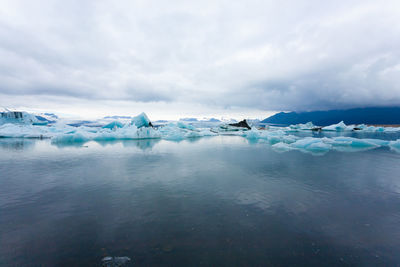 Scenic view of frozen lake against sky