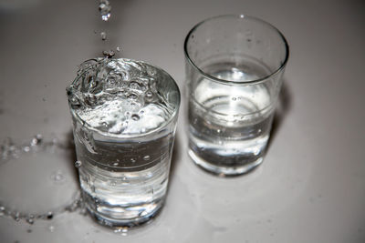 High angle view of water dripping in glass