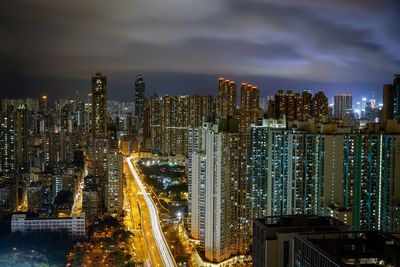Illuminated cityscape against sky at night