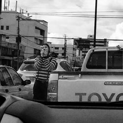 Portrait of man with cars on city in background
