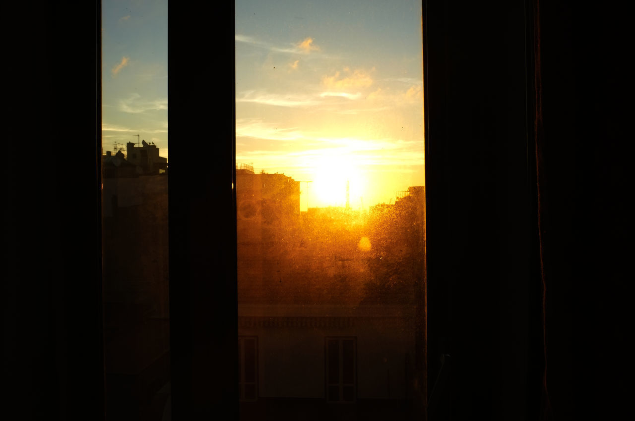 SILHOUETTE BUILDINGS AGAINST SKY DURING SUNSET