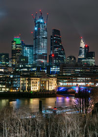 Illuminated buildings in city at night