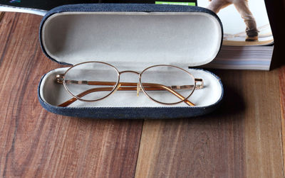 High angle view of eyeglasses in case on table