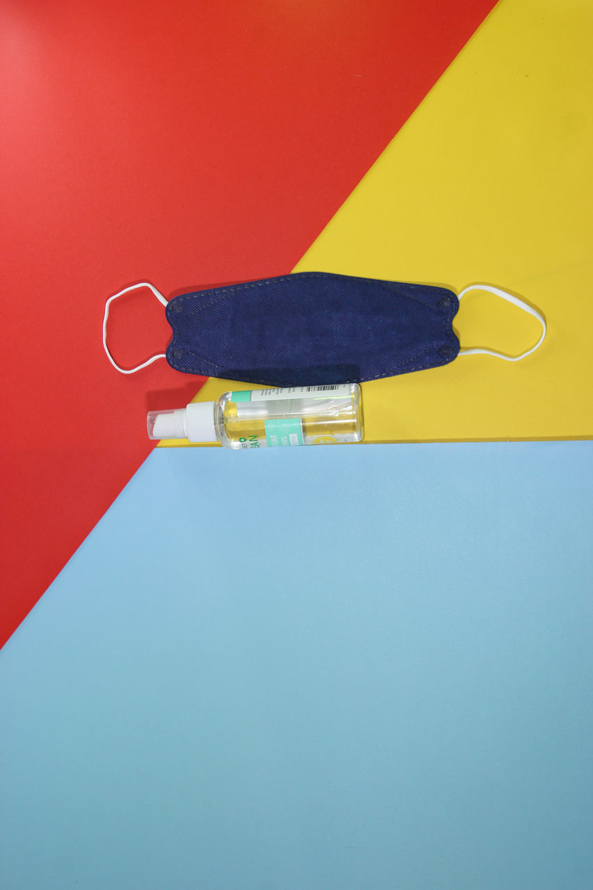 HIGH ANGLE VIEW OF EYEGLASSES ON TABLE AGAINST YELLOW BACKGROUND