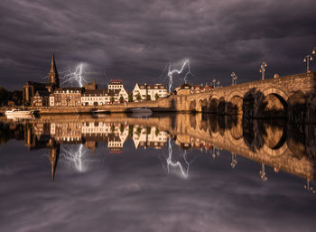 View of bridge over river against cloudy sky