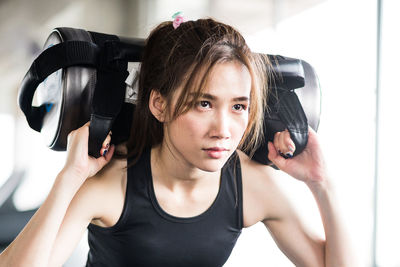 Beautiful young woman exercising at gym