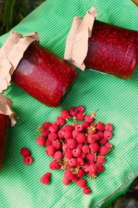 High angle view of hand holding strawberries