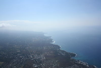 High angle view of sea and cityscape against sky