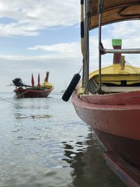 Boats moored in sea against sky