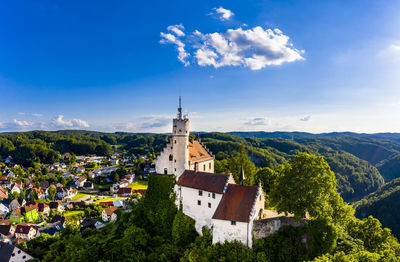 Panoramic view of trees and buildings against sky