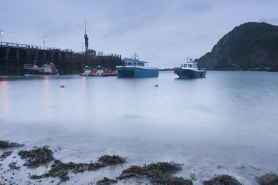 Boats in sea against sky