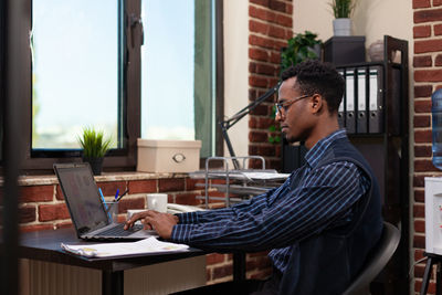 Side view of businessman working in office