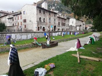 People on field against buildings