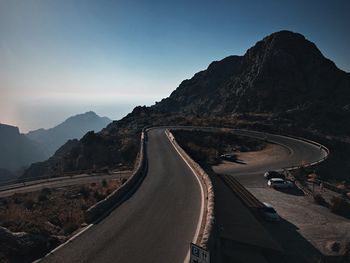 Road passing through mountains against sky