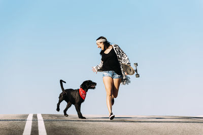 People with dog against clear sky