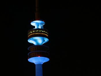 Low angle view of illuminated lamp against clear sky at night