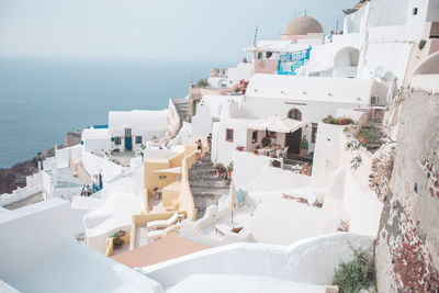 High angle view of buildings by sea against sky