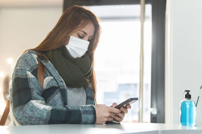 Midsection of woman using mobile phone