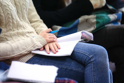 Close-up of woman reading book