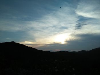 Scenic view of silhouette mountains against sky at sunset