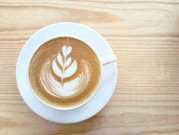 Directly above shot of cappuccino served on table