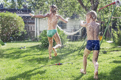 Boy and girl playing in garden