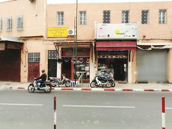 Man riding motorcycle on street in city