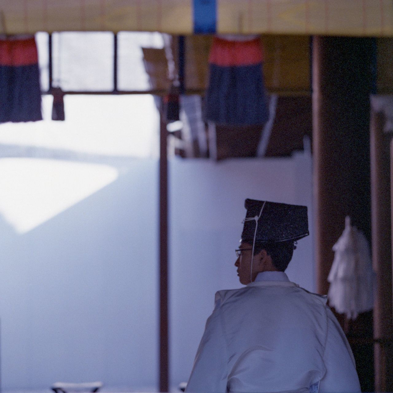 rear view, one person, men, indoors, focus on foreground, headshot, portrait, real people, sitting, lifestyles, publication, book, education, males, day, wall - building feature, paper, leisure activity, architecture