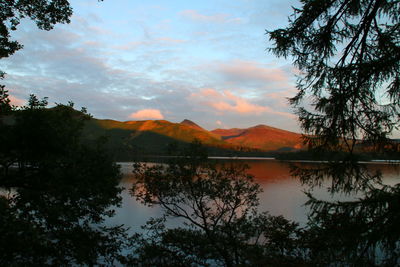 Scenic view of lake against cloudy sky