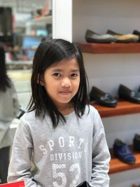 Portrait of smiling girl standing at store
