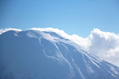 Low angle view of snowcapped mountain against sky