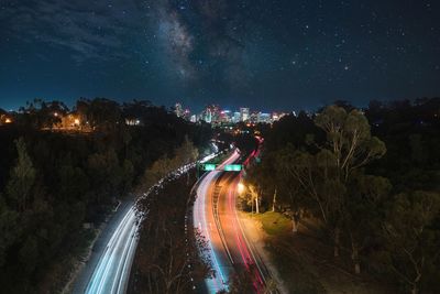 Panoramic view of vehicles on road against sky at night