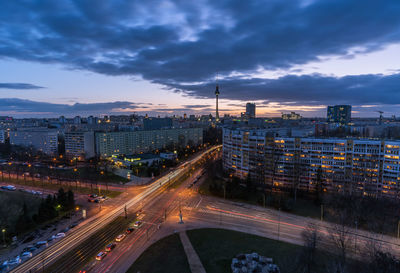 High angle view of light trails on road amidst buildings in city