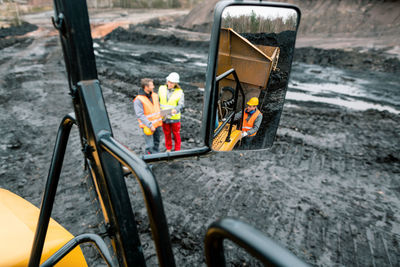 Male and female workers on land