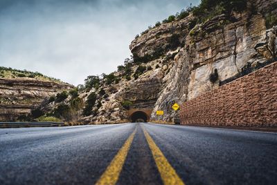 Road amidst mountains against sky