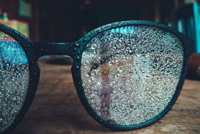 Close-up of sunglasses on glass table