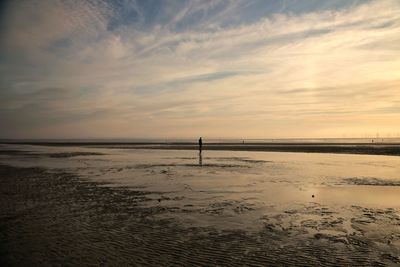 Scenic view of beach against sky during sunset