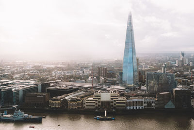 Shard london bridge and thames river against sky in city