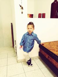 Portrait of smiling boy standing at home