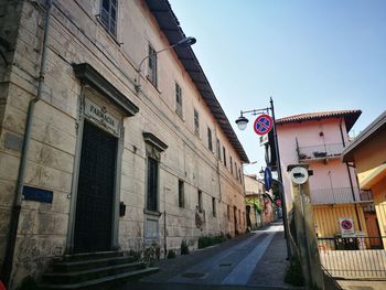 Street amidst buildings against clear sky