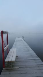 Pier over sea against clear sky