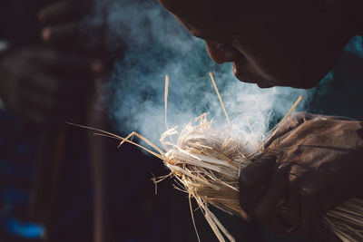 Close-up of hand holding burning fire