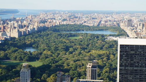 High angle view of buildings and trees against sky