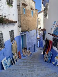 Paintings in alley amidst buildings in city